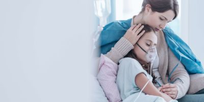 Ältere Schwester und Kind im Krankenhaus atmen mit einer Sauerstoffmaske