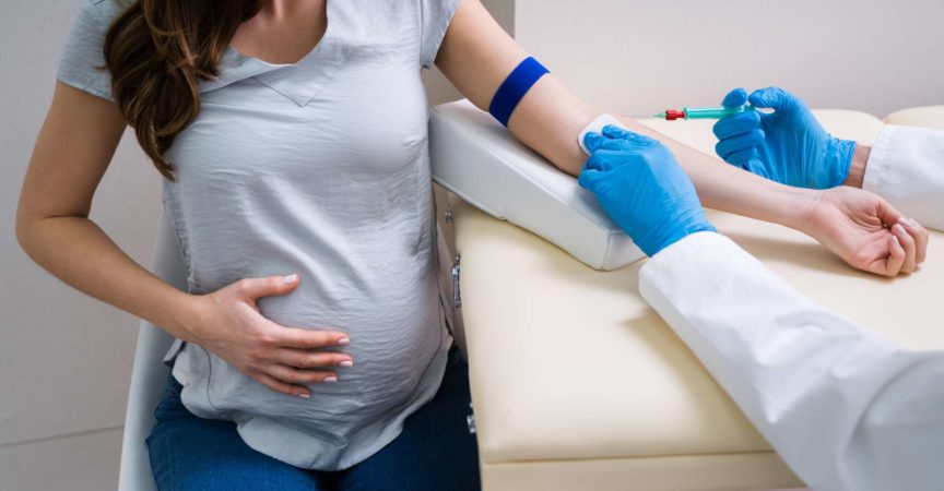 Nahaufnahme des Arztes, der schwangere Patientin mit Spritze injiziert, um Blutprobe zu sammeln