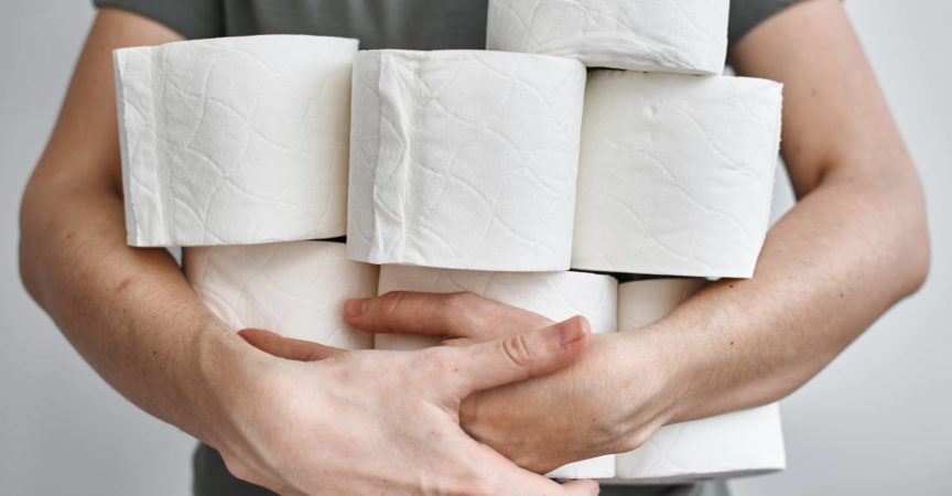 Die Leute füllen Toilettenpapier für die Heimquarantäne von Crownavirus auf. Frau hält viele Rollen Toilettenpapier
