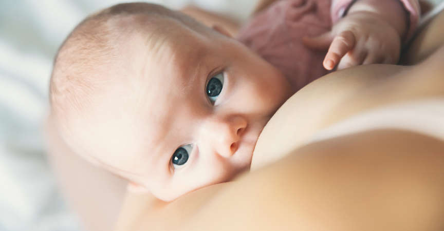 Baby eating mother’s milk. Mother breastfeeding baby.
