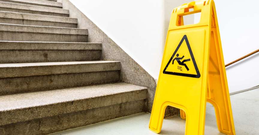 Achtung nasser Boden Schild an einer Treppe