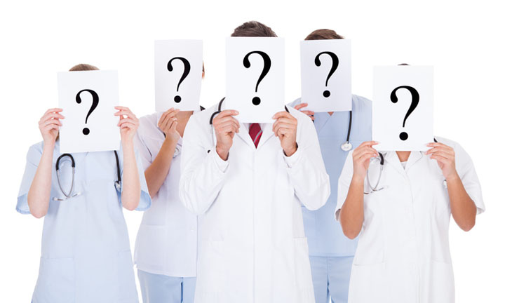 Group Of Doctors Hiding Face With Question Mark Sign Over White Background