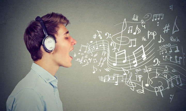 Young man singing with music notes coming out of mouth