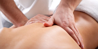 Young woman enjoying a massage in a spa center.