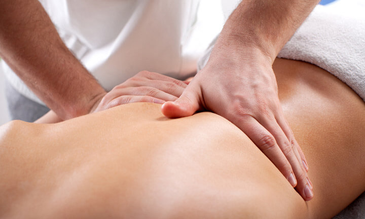 Young woman enjoying a massage in a spa center.