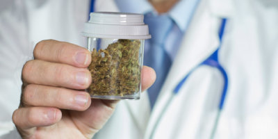 close up of Doctors hands holding medical marijuana