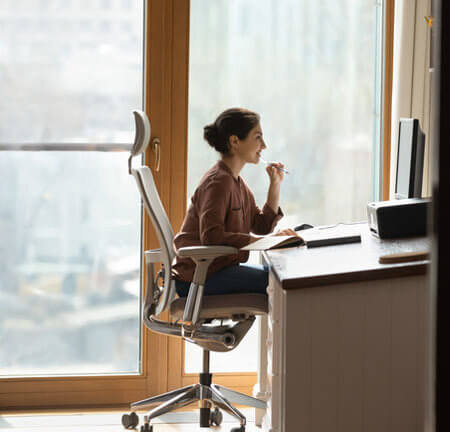 Frau sitzt im Büro vor dem PC