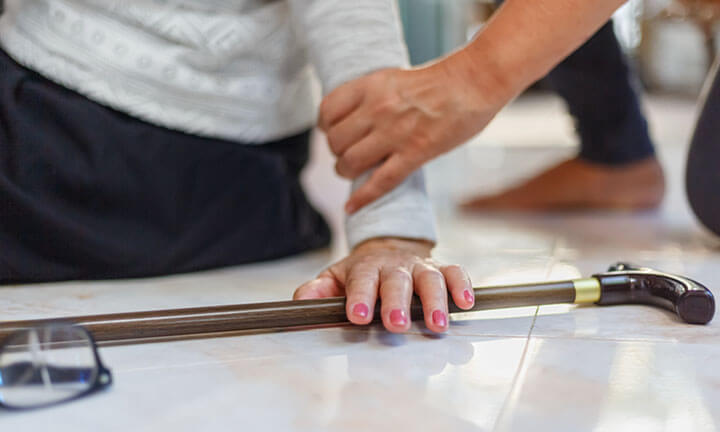 Senior woman falling down at home because stumbled on a door kerb