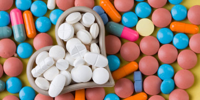 white tablets between colorful heart-shaped medicine