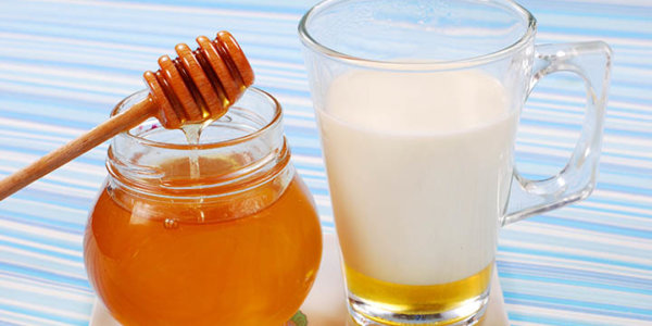 milk with honey in glass as natural medicine