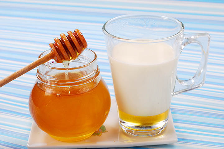 milk with honey in glass as natural medicine